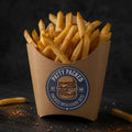 A paperboard fry holder filled with golden french fries on a dark textured surface. The holder has a round blue and brown sticker that reads 'PATTY PACKED' with a burger illustration.