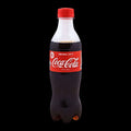 Coca-Cola bottle with red label and cap on a white background